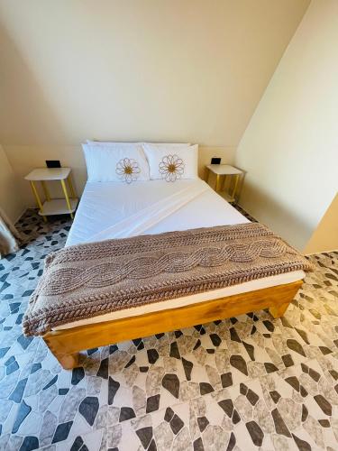 a bedroom with a large bed with two tables at Seabreeze Haven Resort in Maria