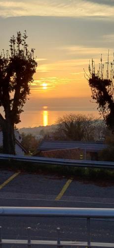 a view of the sunset from a road at Le BéliMont Panorama in Belmont-sur-Lausanne