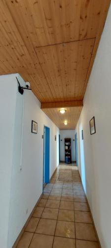 a hallway with a wooden ceiling in a room at Le BéliMont Panorama in Belmont-sur-Lausanne