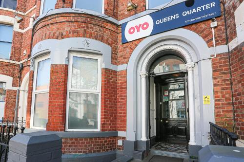 a front door of a building with a sign on it at OYO Queens Quarter in Belfast