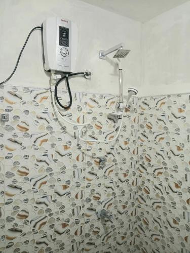 a shower with a fish shower curtain in a bathroom at Ella Mount Villa in Ella