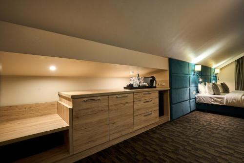 a room with a bed and a desk in a room at F&B Spa Resort (ex. Fomich Hotel) in Bukovel
