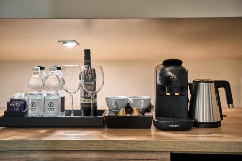a coffee maker and wine glasses on a counter at F&B Spa Resort (ex. Fomich Hotel) in Bukovel