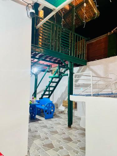 a stairwell in a room with a green stair case at Hadiqah event venue in Mangangpico