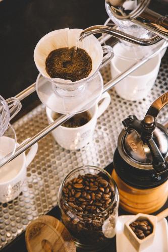 a table with cups of coffee and a bowl of coffee beans at Sakura Terrace The Atelier in Kyoto