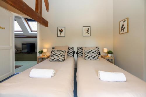 a large bed in a room with two pillows at La Demeure de la Poterie, Wimille & Wimereux in Wimille