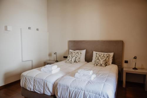 a bedroom with a bed with towels on it at Domus Polymnia, hospitality at its best! in Spílion