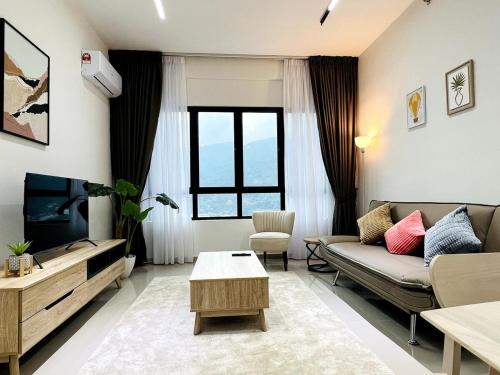a living room with a couch and a tv at SunshineResidence 5pax Near Georgetown in Ayer Itam