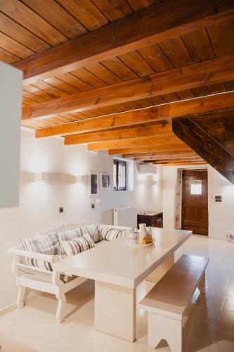 a living room with a couch and a table at Domus Polymnia, hospitality at its best! in Spílion