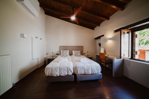 a bedroom with a bed and a window at Domus Polymnia, hospitality at its best! in Spílion