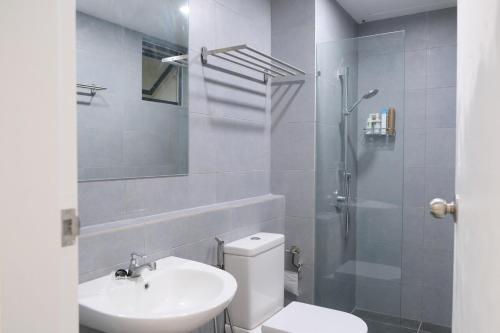 a bathroom with a toilet and a sink and a shower at SunshineResidence 5pax Near Georgetown in Ayer Itam