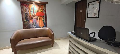 a office with a chair and a laptop on a desk at TIM Service Apartment Goregaon East Near NESCO in Mumbai
