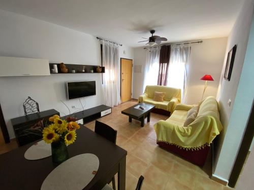 a living room with a couch and a table at Apartamento María Isabel en Los Collados Golf - Aguilas in Águilas