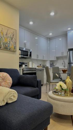 a living room with a couch and a kitchen at Bright Luxurious 2 Bedroom Apartment in Toronto