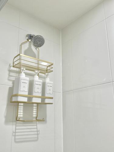 a bathroom with a shelf with bottles on it at Bright Luxurious 2 Bedroom Apartment in Toronto