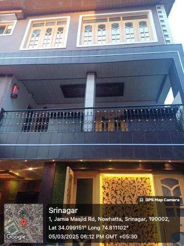 a building with a balcony and a sign in front of it at Winter Wonder in Srinagar