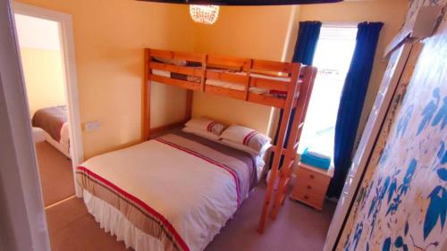 a small bedroom with a bunk bed and a window at Dora Hotel in Blackpool