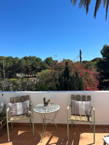 a table and two chairs on a patio at Boutique Hostal La Curandera de Salinas in Ibiza Town