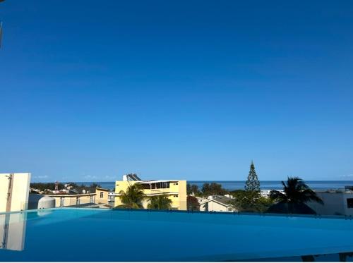 a view of the ocean from the roof of a building at Kensington Seaviews in Flic-en-Flac