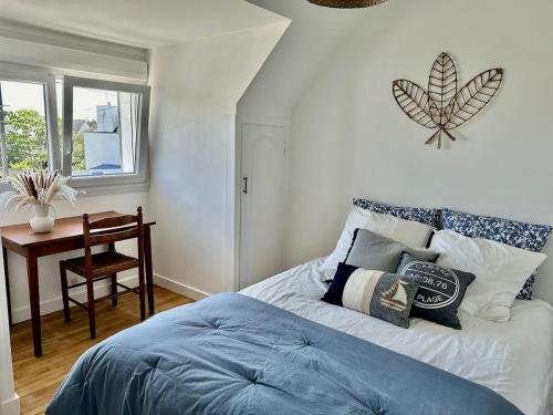 ein Schlafzimmer mit Bett, Schreibtisch und Fenster in der Unterkunft Maison de charme 3 chambres plage de Lodonnec in Loctudy