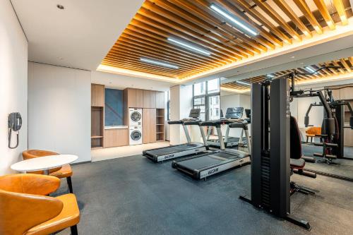 a gym with treadmills and exercise equipment in a room at Holiday Inn Express Shangrao Railway Station by IHG in Shangrao