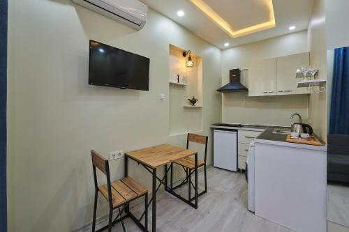 a kitchen with a counter and a table and chairs at Pera Life in Istanbul