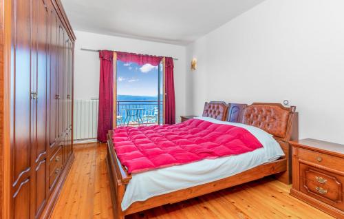 a bedroom with a large bed with a red blanket at Villa with pool Riviera in Crikvenica