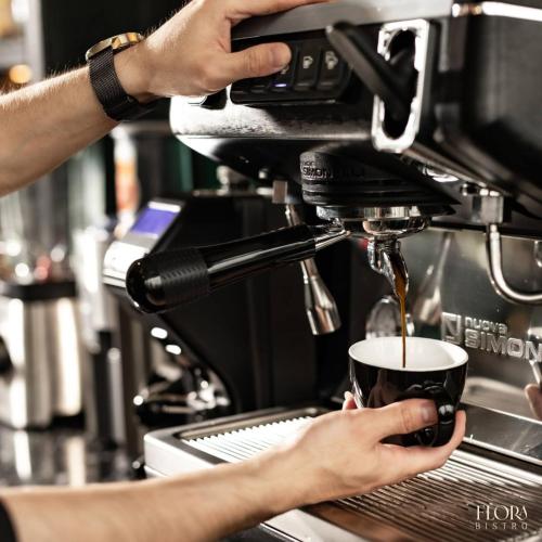 a person is holding a cup of coffee at Bloom in Hanoi - The Residences in Hanoi