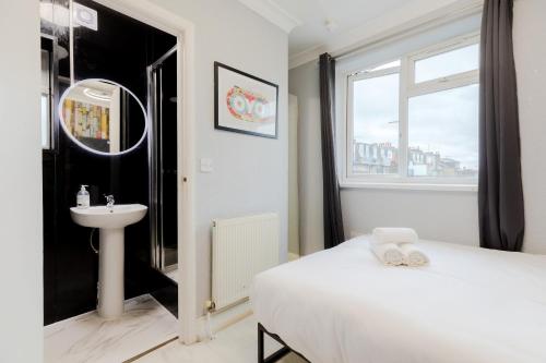 a bedroom with a bed and a sink and a mirror at Orlando hotel in London
