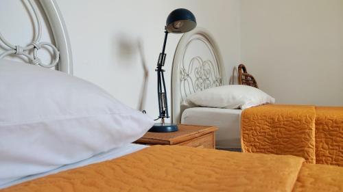 a bedroom with a bed and a lamp on a table at Eco House San Michele in San Michele