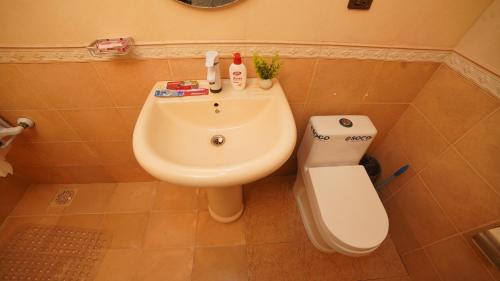a bathroom with a sink and a toilet at Service Apartment by World Inn in Karachi