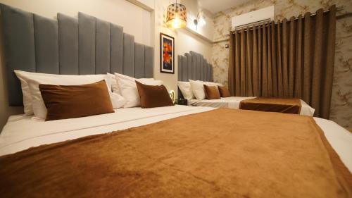 a hotel room with two beds in a room at Service Apartment by World Inn in Karachi