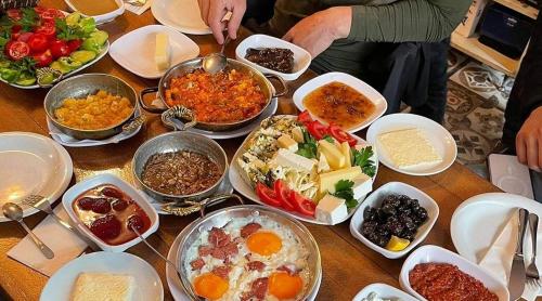 a table with many different dishes of food on it at Palmiye Pansiyon in Adalar