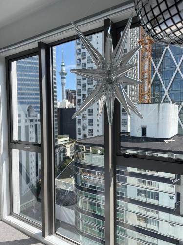 a large silver star on a window with a view at Unbeatable location with FREE parking-Limited offer in Auckland