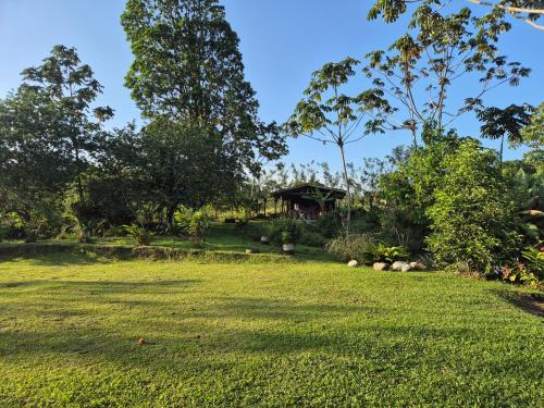 a large yard with a house in the background at Casas de Campo Las Pavitas Cottages "Red Frog" in Palma