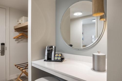 a bathroom with a white counter with a mirror at Holiday Inn Resort Galveston - On The Beach by IHG in Galveston