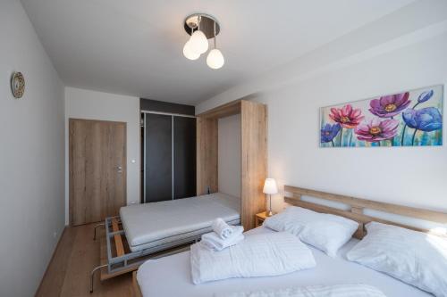 a bedroom with two beds in a room at Aparthotel Klínovec Views in Loučná pod Klínovcem