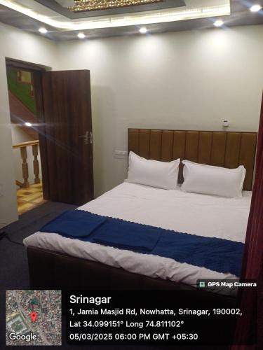 a bedroom with a bed with a wooden headboard at Winter Wonder Home Stay in Srinagar