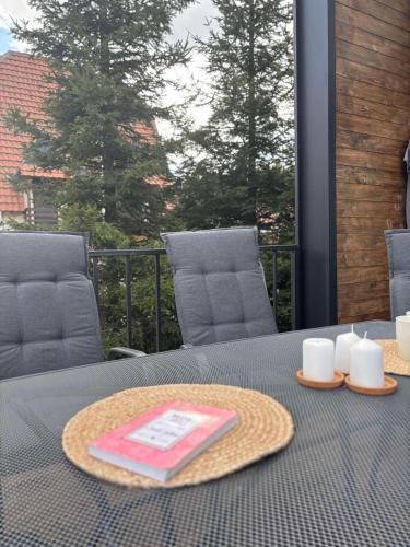 a table with a tray with a napkin and candles on it at Cabins Dolce Vita in Konjska Reka