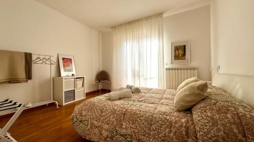 a bedroom with a bed and a dresser and a window at Casa SUN in Civitanova Marche