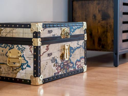 a suitcase with a map on it sitting on the floor at Cosy 2 Bed Terrace Peaceful Village location - Pass the Keys in Oxford