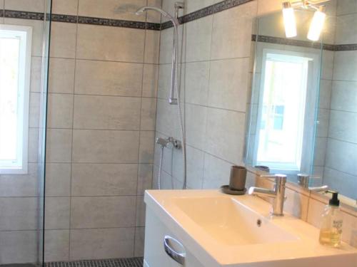 une salle de bain avec un lavabo et une douche avec un miroir dans l'établissement Charmante maison, jardin paysagé, piscine, proche sites préhistoriques et Sarlat - FR-1-616-195, à Pazayac