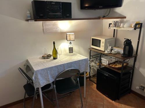 a small table with a bottle of wine on it at Casamanu in Montebelluna