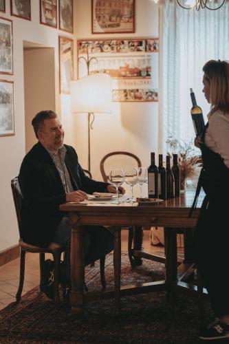 a man sitting at a table with a woman at Locanda Poggioleone in Castiglione del Lago