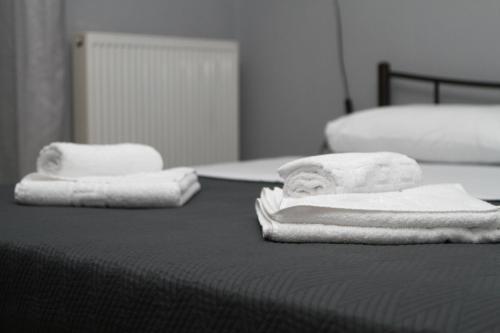 two towels are sitting on top of a bed at Fertoun apartment in Chaïdeftón
