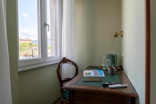 a desk with a window and a book on it at Dimore Morelli Brescia in Brescia
