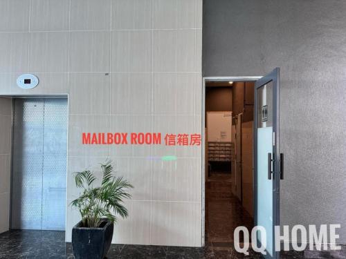 a hallway of a building with a door and a plant at Nice Seaview Water Front Apartment 3R3B 超舒适海景房间-3房3卫 in Port Dickson