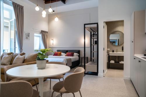 a living room with a bed and a table and chairs at Monteroduni 22 - Chiaia Design Rooms in Naples