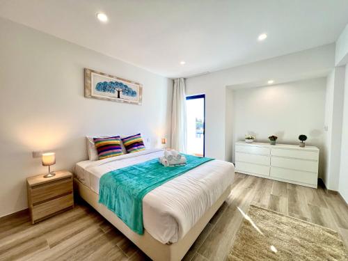 a bedroom with a large bed and a window at Vilamoura Design 2 by Homing in Vilamoura