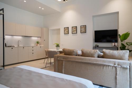 a living room with two couches and a kitchen at Monteroduni 22 - Chiaia Design Rooms in Naples